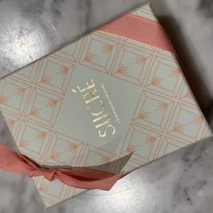 a close up of a gift box on a marble surface