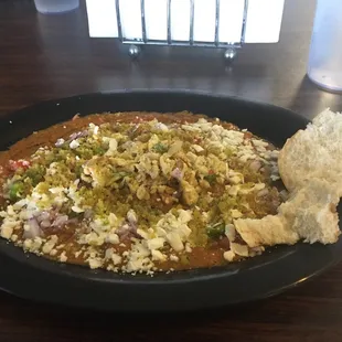 Foul special (foul, sprinkled with eggs and falafel).  Served with yummy warm bread.