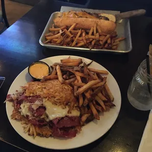 Top: Philly Cheese Steak Sub with a side of fries Bottom: Potato Pancake Reuben with a side of fries and a side of Thousand Island dressing