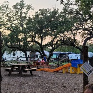a young boy sitting at a picnic table