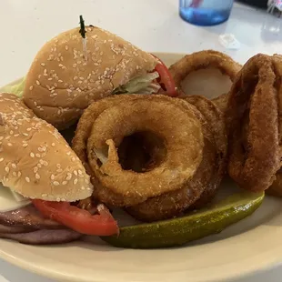 Ham sandwich with onion rings.