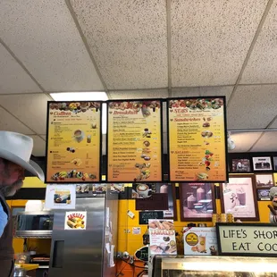 a man in a cowboy hat at the counter