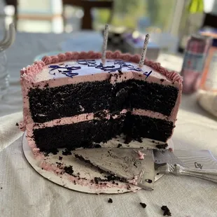 The cross section of the chocolate cake with raspberry buttercream.