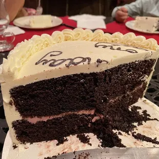 Two layers chocolate cake with raspberry curd filling and vanilla Swiss meringue buttercream frosting