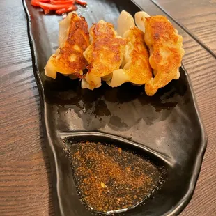 a plate of dumplings on a wooden table