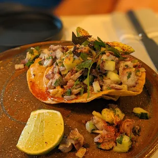 Tostada grilled octopus, salsa chintextle, white bean refrito $16