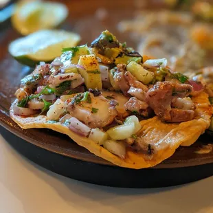 Tostada grilled octopus, salsa chintextle, white bean refrito $16