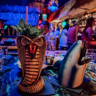 a close up of a tiki with a shark on it