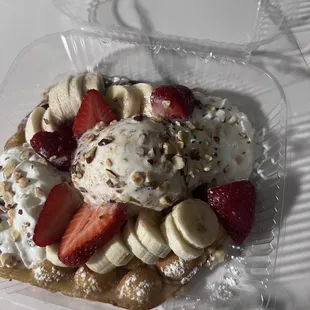 Bubble Waffle with Ice Cream Flat with chocolate sauce, almonds, pecan ice cream, strawberries and banana. Oh and whipped cream on top!