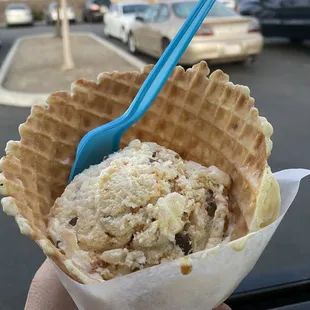 Butterfinger scoop in a freshly made waffle cone