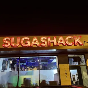 a car parked in front of a suga shack