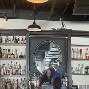 two women sitting at a bar