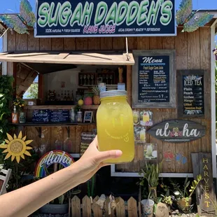 a person holding a glass of juice