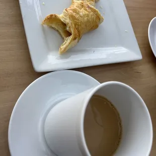 a croissant and a cup of coffee