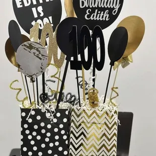 a black and gold birthday centerpiece