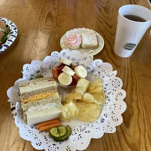 a plate of sandwiches and chips