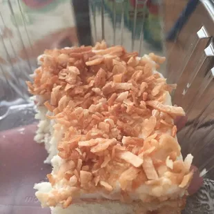 Yummy half eaten toasted coconut cake.