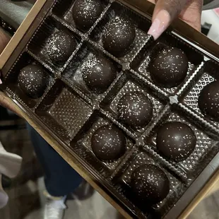 a person holding a box of chocolates