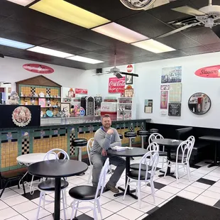 a man sitting at a table in a diner