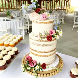 a wedding cake and cupcakes