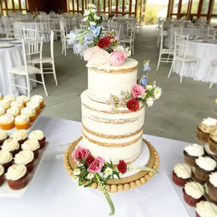 a wedding cake and cupcakes
