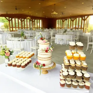a wedding cake and cupcakes