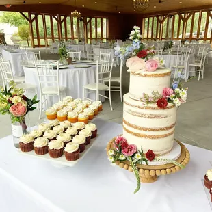 a wedding cake and cupcakes