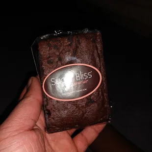  hand holding a chocolate brownie