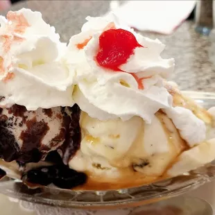 Banana Split - banana, cookies &apos;n cream ice cream, hot fudge sauce, chocolate chip ice cream, caramel sauce, fluffy whip,  cherry