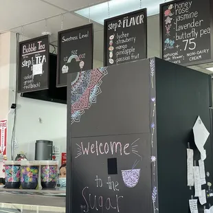 a black refrigerator with chalk writing on it