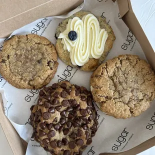 (Clockwise, Top left) oatmeal chocolate chunk, lemon, blueberry, oatmeal cream, pie, &amp; chocolate chip bomb