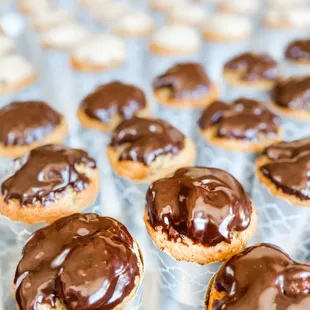 a tray of chocolate covered donuts
