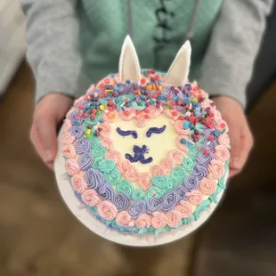 a person holding a birthday cake