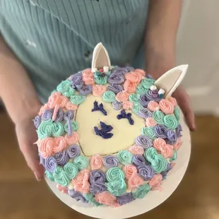 a person holding a cake