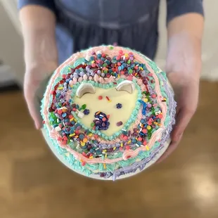 a person holding a cake