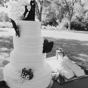 a bride and groom on top of a wedding cake
