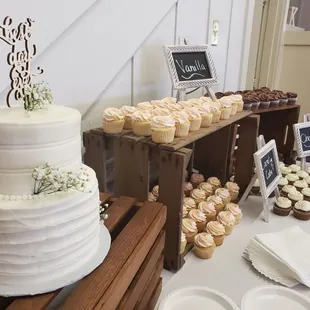 a wedding cake and cupcakes