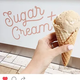 a hand holding an ice cream cone