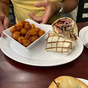 a man sitting at a table with a plate of food