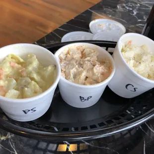 Sides (left is regular potato salad, middle is bacon potato salad, right is coleslaw).