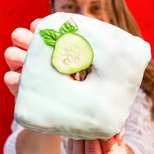 a woman holding a cucumber