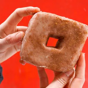a hand holding a doughnut