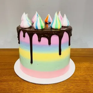 Rainbow cake with lemon sponge and raspberry white chocolate icing and a dark chocolate drip top. So good!