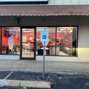 Open sign on, workers visible, doors locked, and it&apos;s business hours.