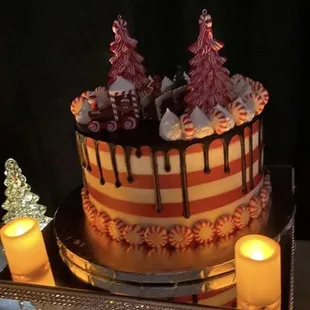 Red velvet cake with cream cheese filling, peppermints around base and our provided Christmas train
