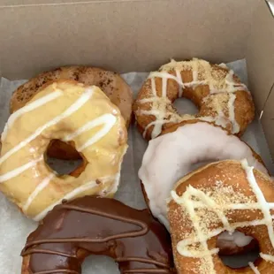 Nutella Glazed Donut, Cinnamon Crunch Donut, Vanilla Bean Glazed Donut, signature donut orange cream, Caramel Espresso Donut.