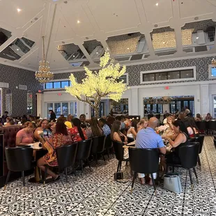 a large group of people sitting at tables