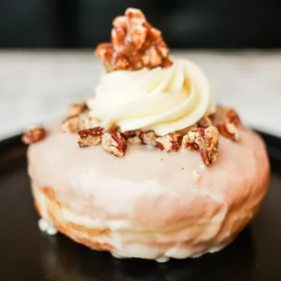 Maple Glazed Donut with spiced pecans, vanilla buttercream, and pecan praline