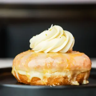 Orange Creamsicle Donut - Orange zest glaze w/orange caramel drizzle topped with vanilla butter cream  and orange zest