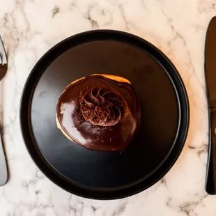 Chocolate Cheesecake Donut - choc fudge glaze filled with Chocolate Cheesecake Mousse topped with whipped chocolate ganache